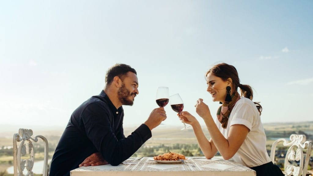 people holding glasses and eating
