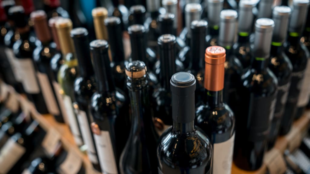 different types of wine bottles on a rack