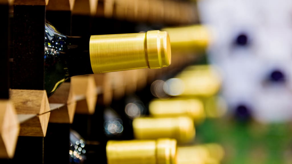 yellow bottle caps on a wine rack